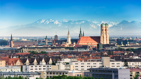 A photo of the Munich skyline and snow capped mountains