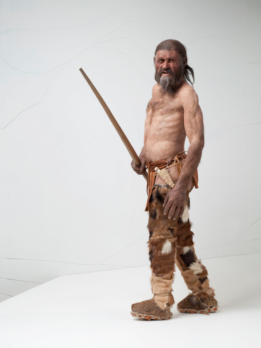 A reconstruction of Ötzi the Iceman is on display at the South Tyrol Museum of Archaeology. Based on his DNA, scientists now believe he had dark skin and eyes and may have been bald.