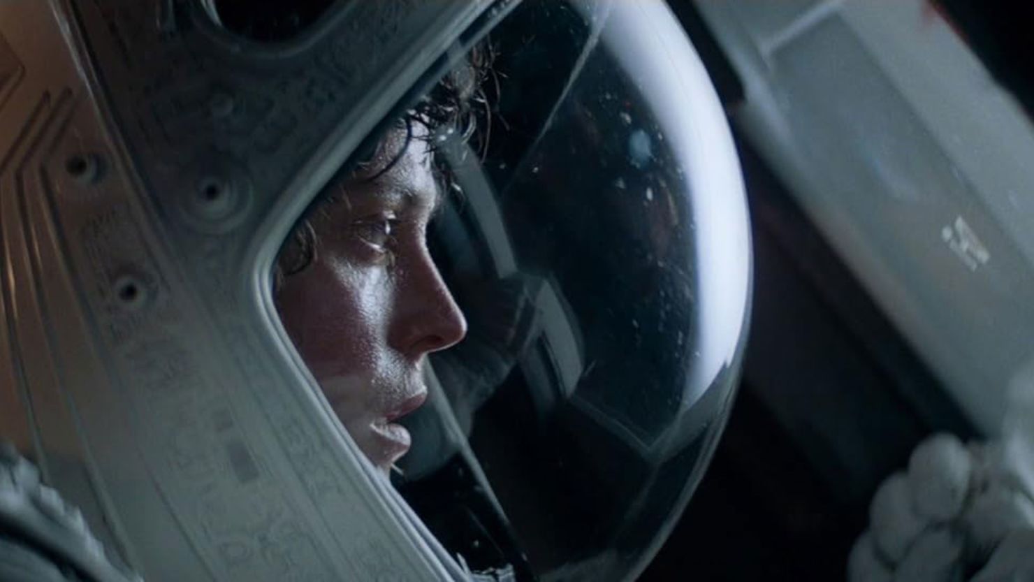 A still from the movie Alien, showing Sigourney Weaver in a space helmet. 
