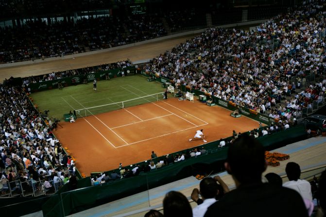 Nadal, top left, plays Roger Federer during a special “Battle of the Surfaces” tennis match in Palma, Spain, in May 2007. Half of the court was on clay, Nadal’s specialty, and half was on grass, Federer’s specialty. Nadal won the three-set exhibition in front of his home crowd.