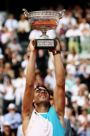 Nadal lifts the Philippe Chatrier Trophy after defeating Federer to win the French Open in June 2007. It was his third straight French Open title.