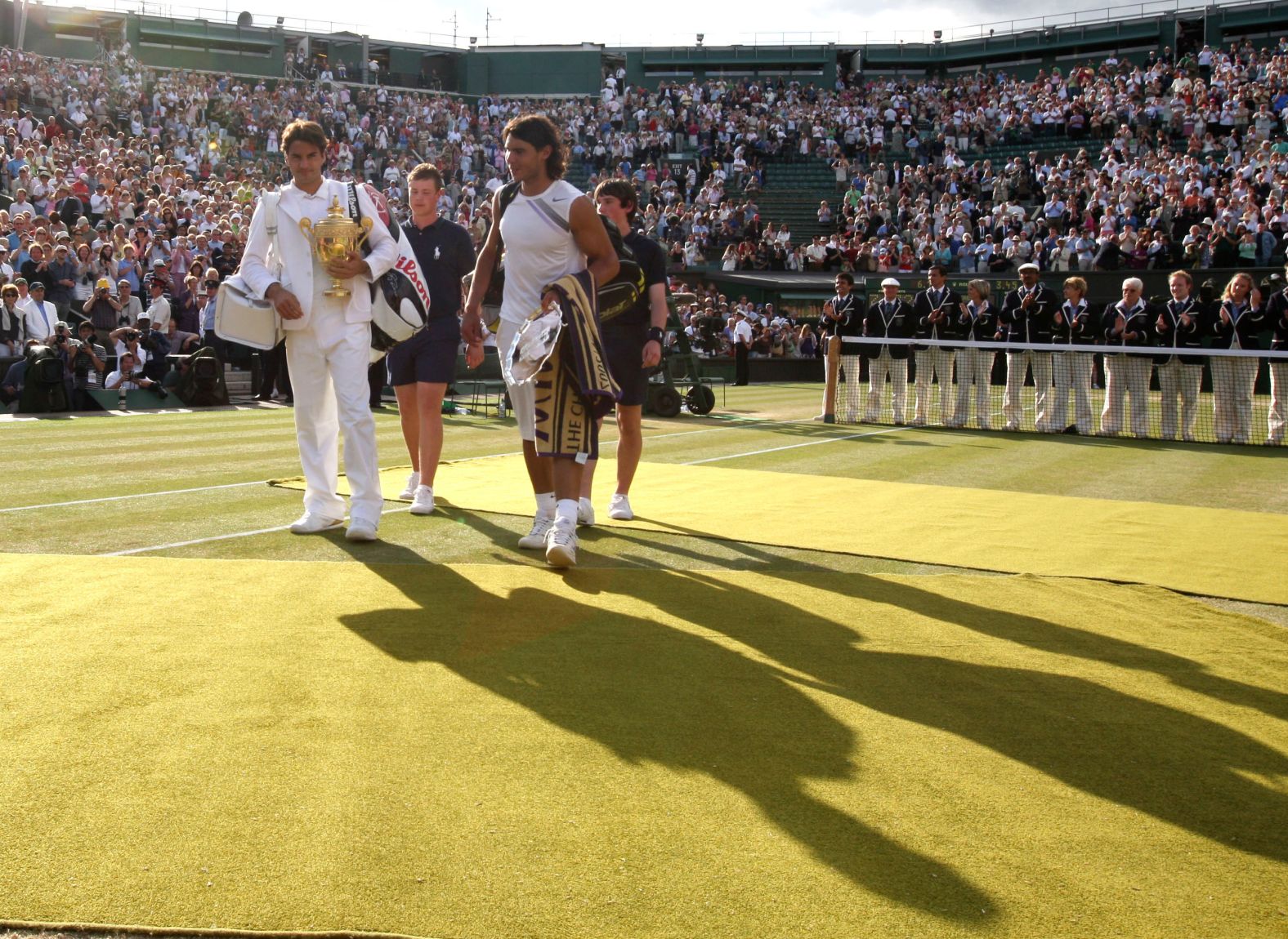 Nadal and Federer leave the court together after the Wimbledon final in July 2007. Federer had just won for the fifth straight year.