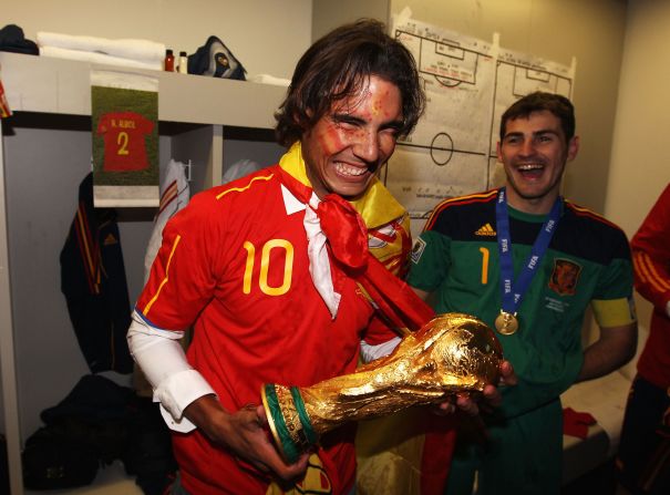 Nadal celebrates in the locker room with Spain’s football team after it won the FIFA World Cup in July 2010. At right is Spanish goalkeeper Iker Casillas.