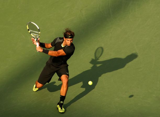 Nadal hits a shot in the US Open final in September 2010. Nadal defeated Djokovic to win his first US Open and complete a career grand slam.