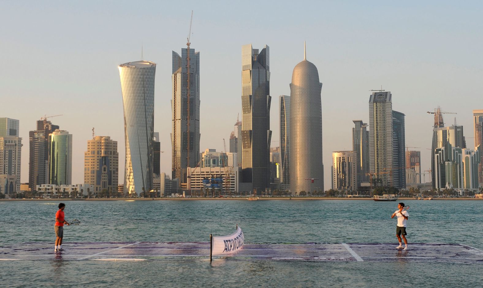 Nadal and Federer play on a floating court to promote the city of Doha, Qatar, ahead of the Qatar Open in 2011.