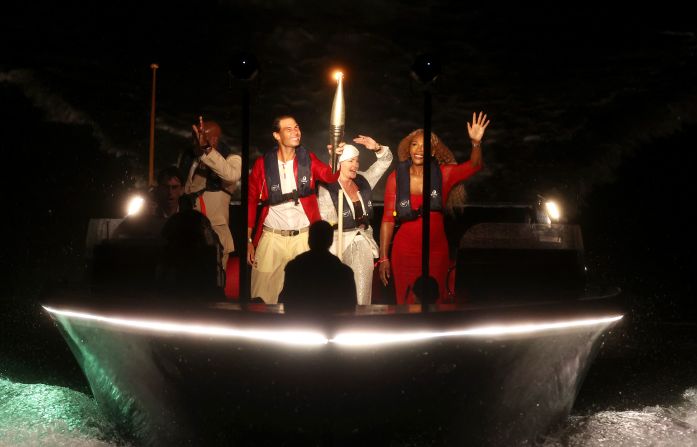 Nadal carries the Olympic flame on a boat during the <a href="https://www.cnn.com/2024/07/26/sport/gallery/opening-ceremony-paris-summer-olympics/index.html">opening ceremony of the Paris Olympics</a> in July 2024. With him are a few famous former Olympians: from left, Carl Lewis, Nadia Comăneci and Serena Williams.