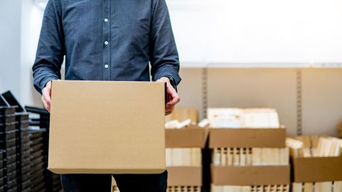 Person holding a box as they organize for their move.