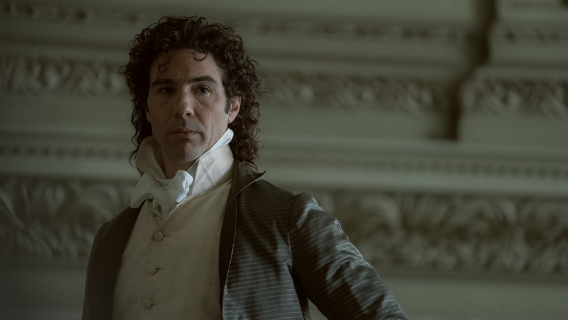 Paul Barras (played by Tahar Rahim) shows off a sumptuous curly mullet in "Napoleon."
