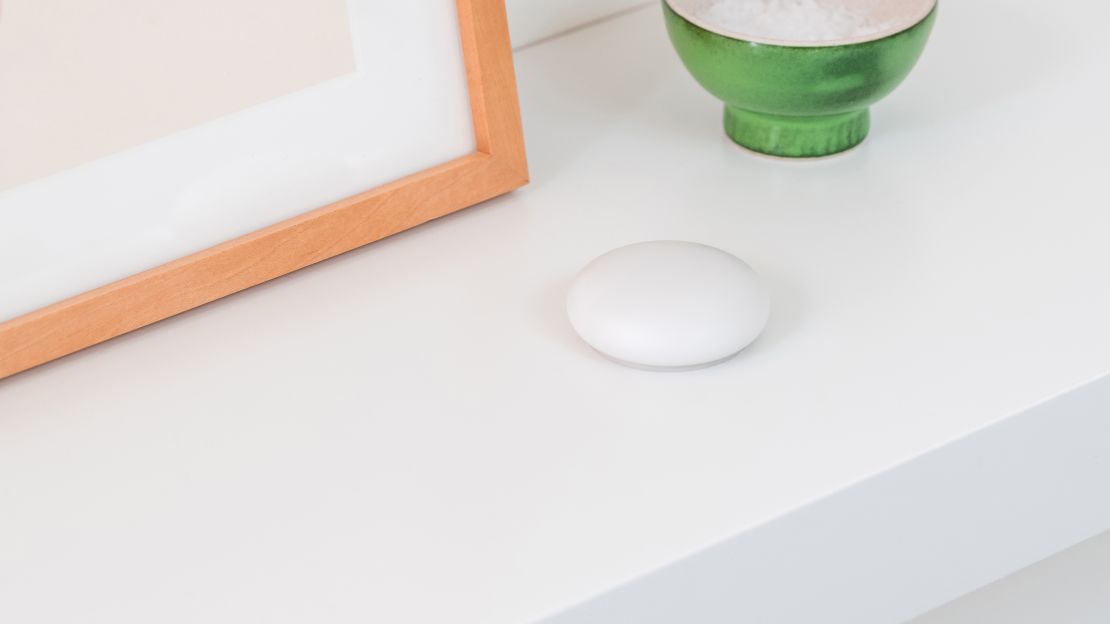 a white Nest Temperature Sensor looks like a pebble that's practically blending in on a white countertop