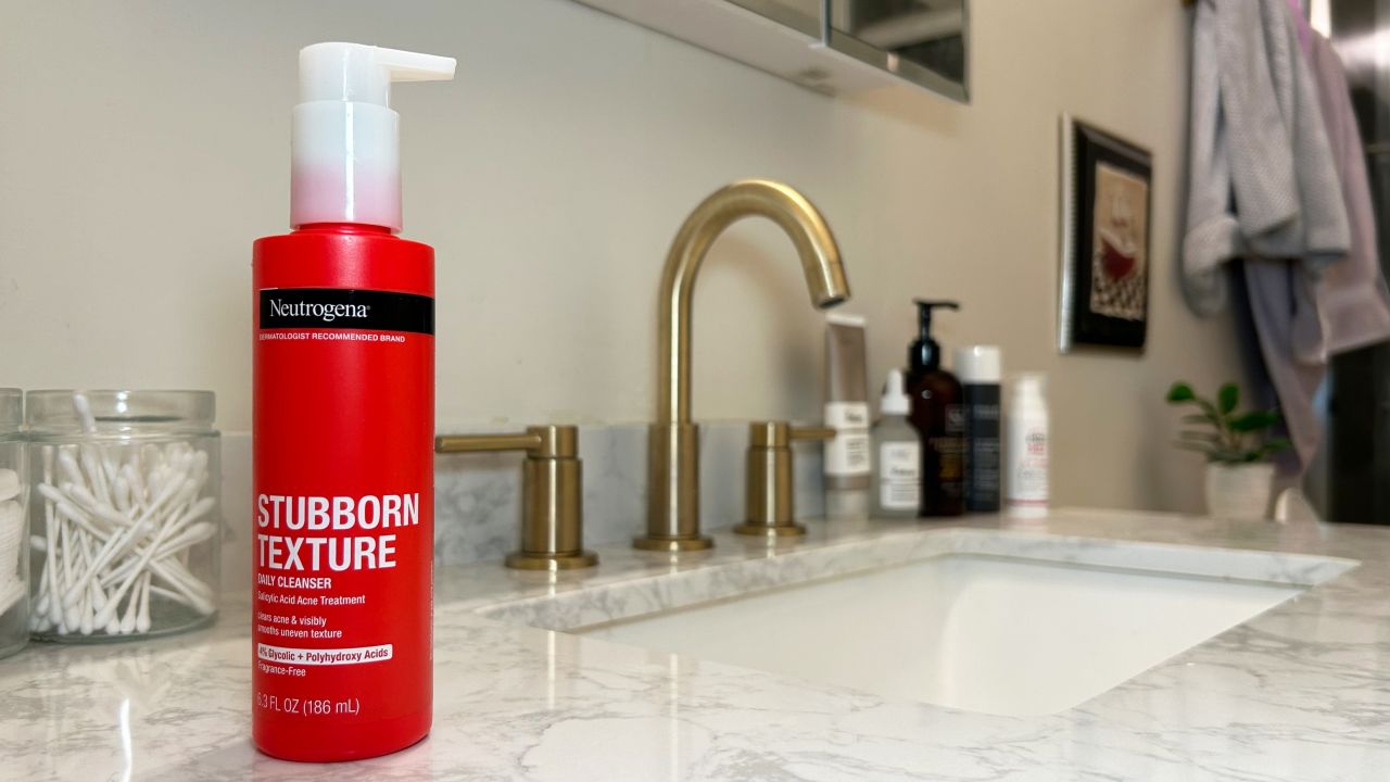 Neutrogena stubborn texture acne cleanser red bottle in front of bathroom sink