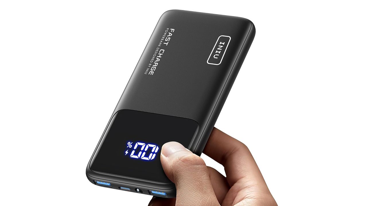 A photo of a hand holding the INIU portable charger