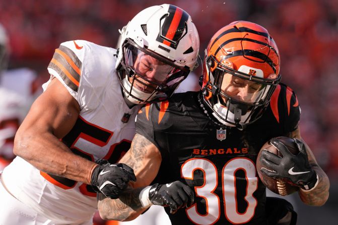 Cincinnati Bengals running back Chase Brown, right, carries the ball as Cleveland Browns linebacker Jordan Hicks defends during the Bengals' 24-6 victory in Cincinnati on Sunday, December 22.