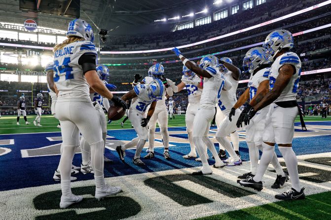 Detroit Lions safety Brian Branch, center, celebrates an interception with his teammates during a game against the Dallas Cowboys in Arlington, Texas, on October 13. The Lions trounced the Cowboys 47-9.