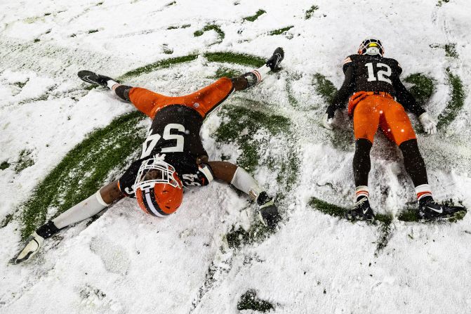 Cleveland Browns defensive end Ogbo Okoronkwo and safety Rodney McLeod Jr. make snow angels after <a href="index.php?page=&url=https%3A%2F%2Fwww.cnn.com%2F2024%2F11%2F22%2Fsport%2Fcleveland-browns-pittsburgh-steelers-tnf-nfl-spt-intl%2Findex.html">beating the Pittsburgh Steelers 24-19</a> in Cleveland on Thursday, November 21.