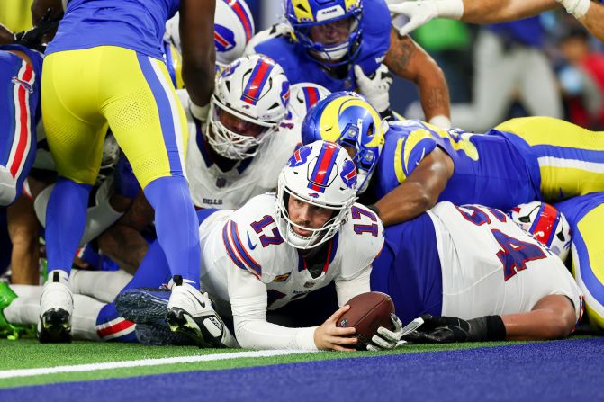 Buffalo Bills quarterback Josh Allen scores a touchdown during his team's 44-42 loss to the Los Angeles Rams at SoFi Stadium in Inglewood, California, on Sunday, December 8. Allen became the first NFL quarterback to score <a href="index.php?page=&url=https%3A%2F%2Fwww.cnn.com%2F2024%2F12%2F08%2Fsport%2Fbuffalo-bills-josh-allen-history-los-angeles-rams-spt%3Fbrand-site%3Dcnn%26language%3Den%26agent%3Dany%26region%3Dany">three passing touchdowns and three rushing touchdowns</a> in a single game.