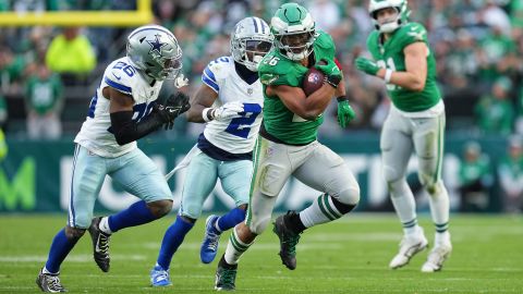 PHILADELPHIA, PENNSYLVANIA - DECEMBER 29: Saquon Barkley #26 of the Philadelphia Eagles runs the ball against DaRon Bland #26 and Jourdan Lewis #2 of the Dallas Cowboys at Lincoln Financial Field on December 29, 2024 in Philadelphia, Pennsylvania. (Photo by Mitchell Leff/Getty Images)