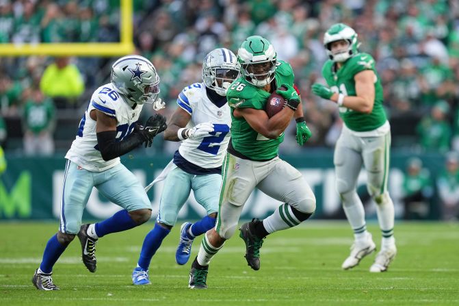 Philadelphia Eagles running back Saquon Barkley carries the ball in Philadelphia on Sunday, December 29. Barkley became just the ninth player in NFL history to <a href="index.php?page=&url=https%3A%2F%2Fwww.cnn.com%2F2024%2F12%2F29%2Fsport%2Fphiladelphia-eagles-saquon-barkley-2000-yards-milestone-spt%2Findex.html">rush for 2,000 yards</a> in a single<strong> </strong>season. The Eagles also clinched the NFC East division crown with their 41-7 victory over the Dallas Cowboys.