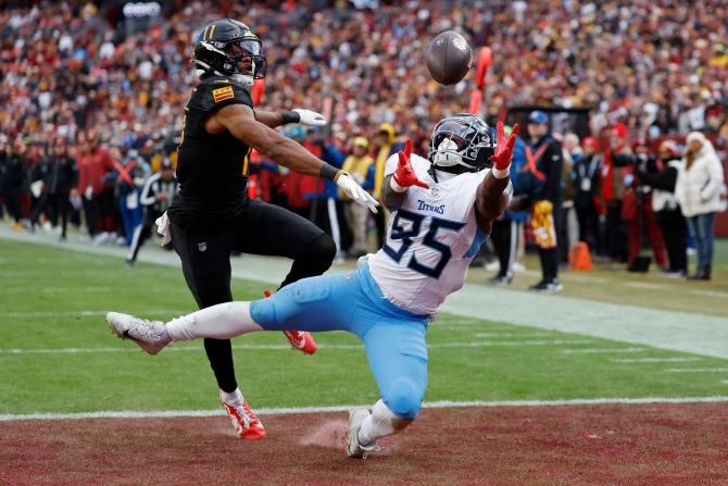 Tennessee Titans tight end Chig Okonkwo attempts to catch a pass in the end zone as Washington Commanders safety Jeremy Chinn defends in Landover, Maryland, on December 1. The Commanders won 42-19.