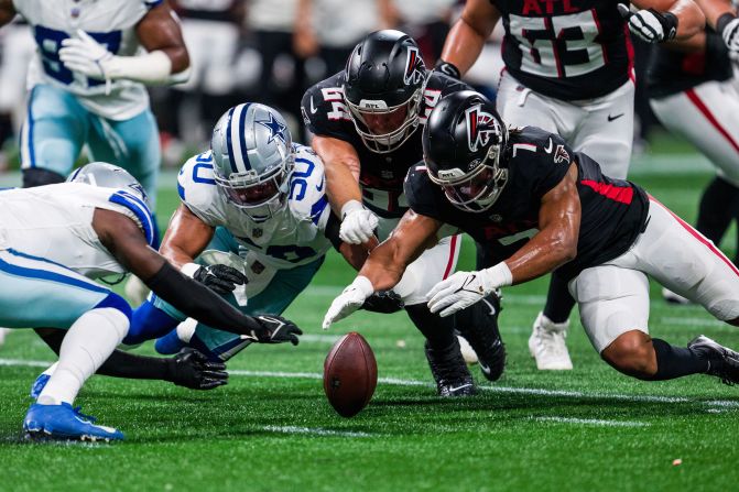 Dallas Cowboys safety Donovan Wilson, linebacker Eric Kendricks, Atlanta Falcons guard Ryan Neuzil and running back Bijan Robinson dive for a loose ball in Atlanta on Sunday, November 3. The Falcons defeated the Cowboys 27-21.