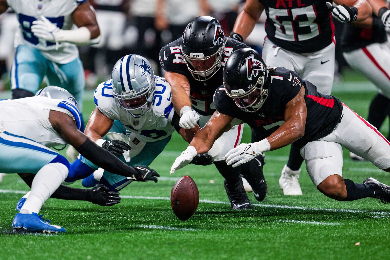 Dallas Cowboys safety Donovan Wilson, linebacker Eric Kendricks, Atlanta Falcons guard Ryan Neuzil and running back Bijan Robinson dive for a loose ball in Atlanta on Sunday, November 3. The Falcons defeated the Cowboys 27-21.