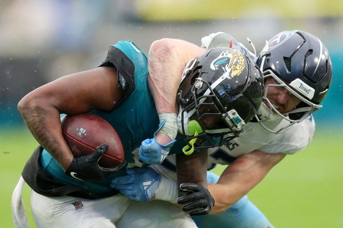 Tennessee Titans linebacker Luke Gifford tackles Jacksonville Jaguars running back Travis Etienne Jr. in Jacksonville, Florida, on December 29. The Jaguars won 20-13.