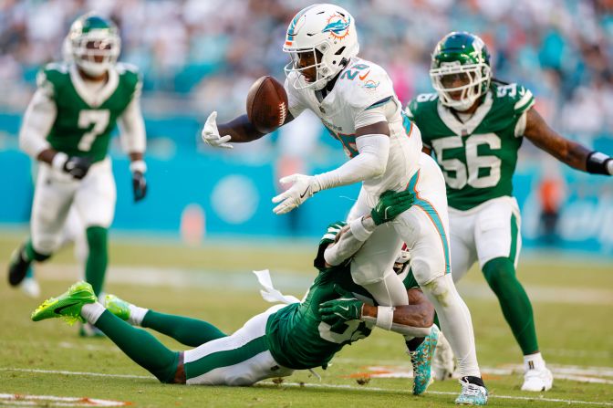 Miami Dolphins running back De'Von Achane bobbles the ball during the Dolphins 32-26 win against the New York Jets in Miami Gardens, Florida, on December 8.