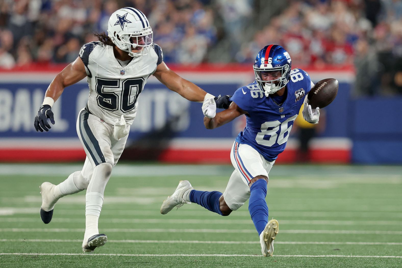 New York Giants wide receiver Darius Slayton bobbles the ball as he runs against Dallas Cowboys linebacker Eric Kendricks during the Giants' 20-15 loss to the Cowboys in East Rutherford, New Jersey, on Thursday, September 26.