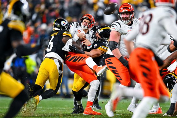 Cincinnati Bengals quarterback Joe Burrow fumbles as he is sacked by Alex Highsmith and Patrick Queen of the Pittsburgh Steelers in Pittsburgh on Saturday, January 4. The Bengals won 19-17.