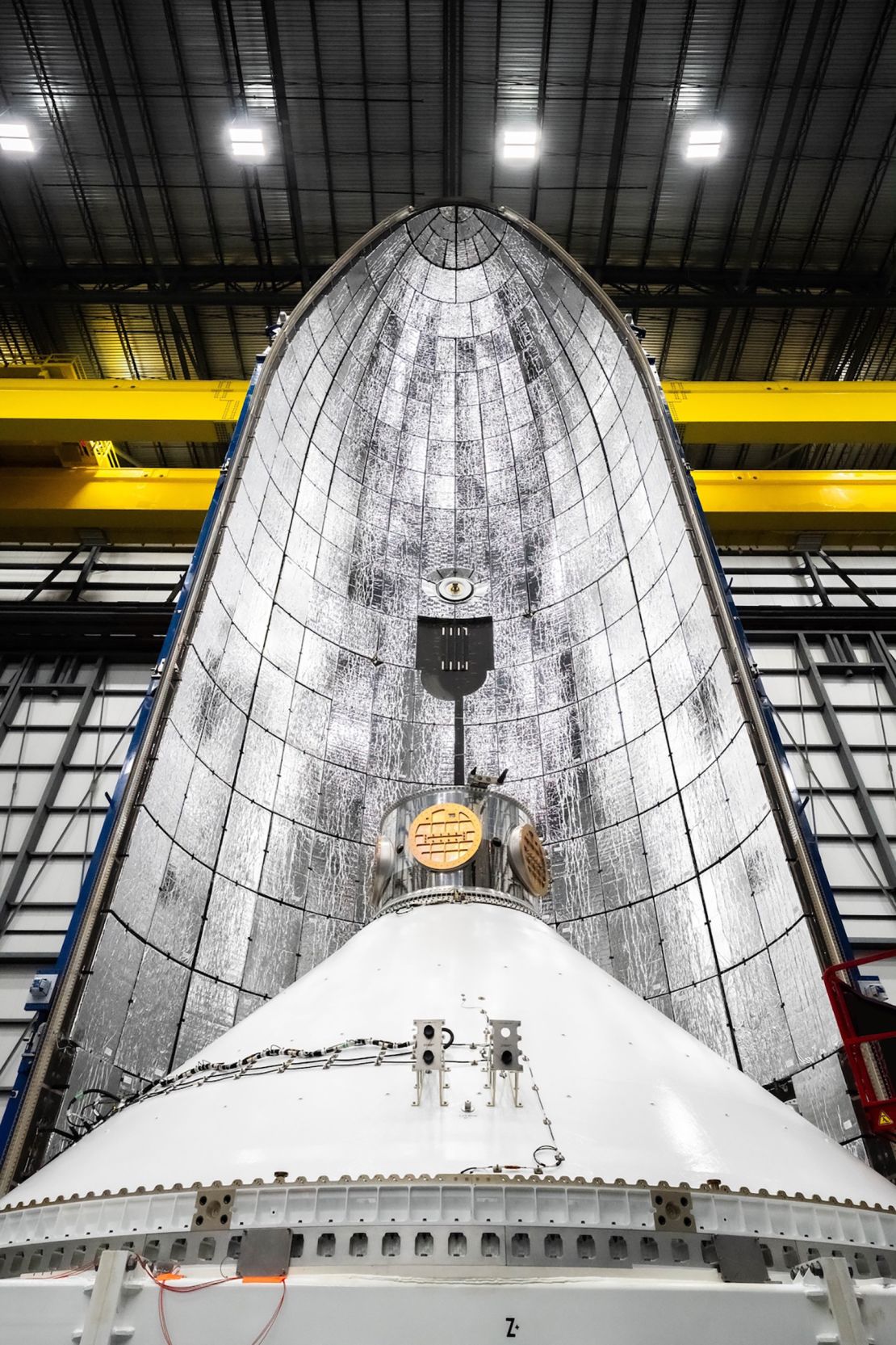 The Blue Ring Pathfinder demonstrator (foreground), is seen with one half of the New Glenn rocket's payload fairing, or nose cone (background), on December 9, 2024. The demo will test technology that will be incoporated in Blue Origin's proposed spacecraft called Blue Ring.