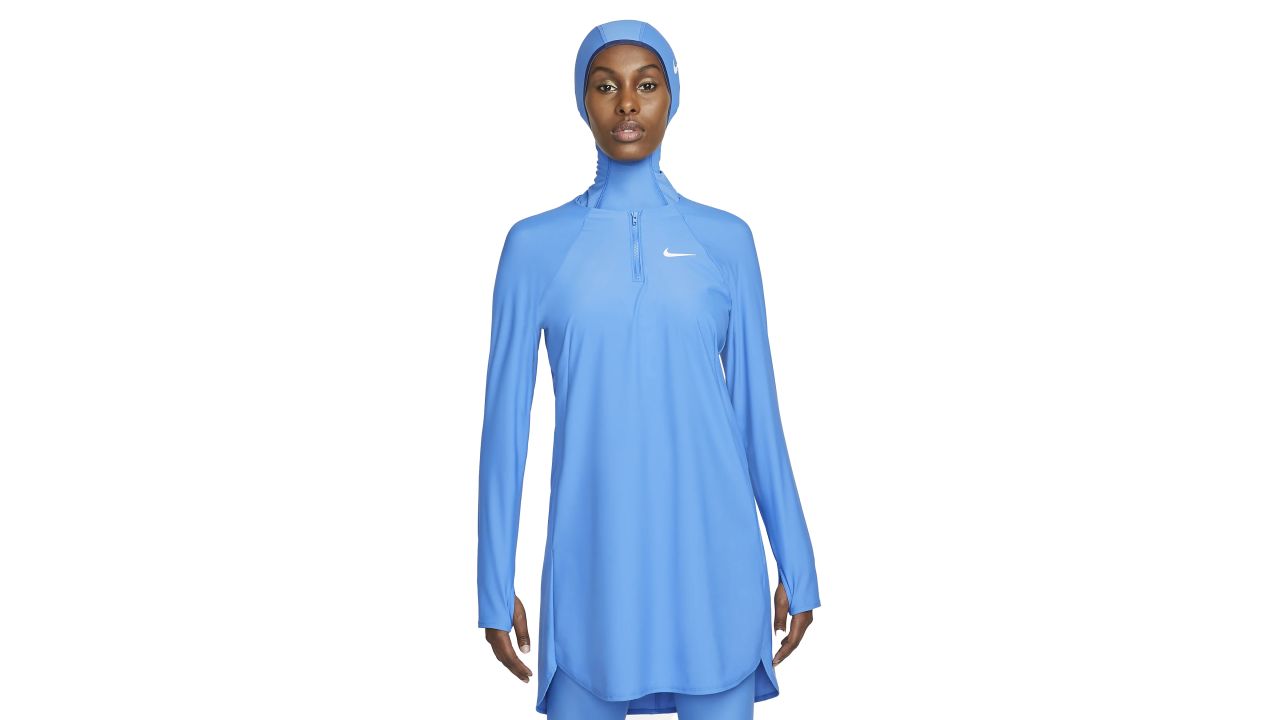 Woman wearing Nike Victory Women's Full-Coverage Swim Tunic in blue