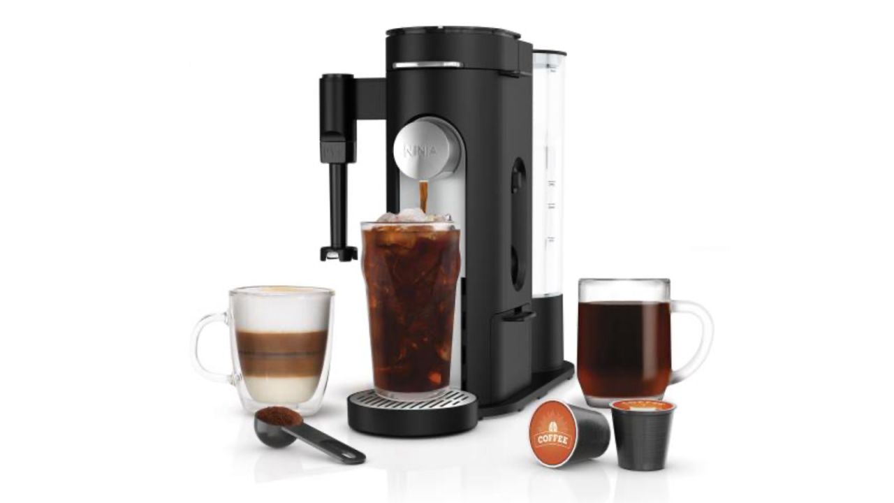 black Single-Serve Coffee Maker surrounded by three different coffee beverages and two K-Cup coffee pods