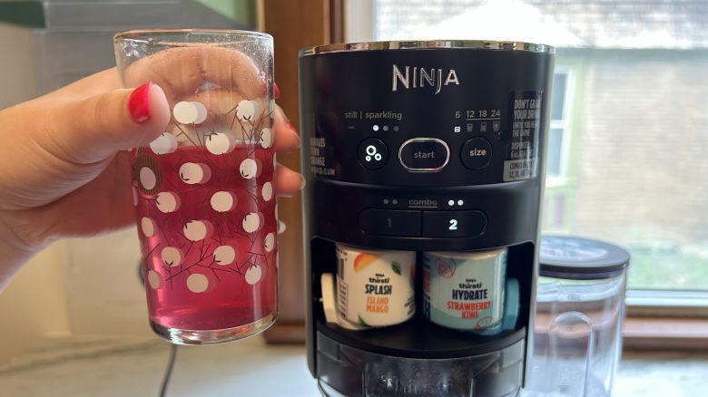 Ninja Thirsti drink system with glass of flavored seltzer Underscored