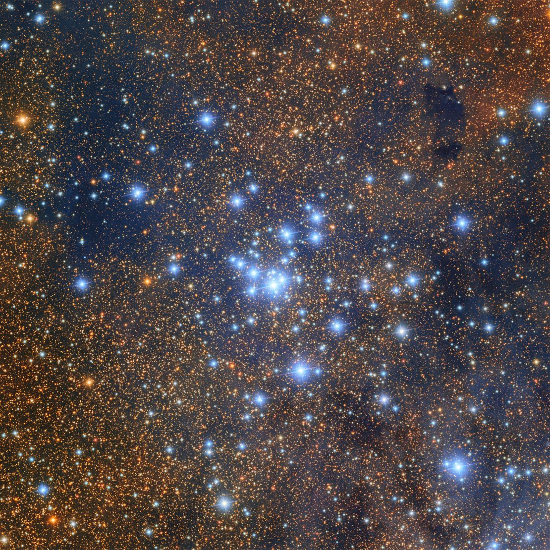 The open star cluster Messier 21, located near the Trifid Nebula, is young and brimming with small, dim stars.