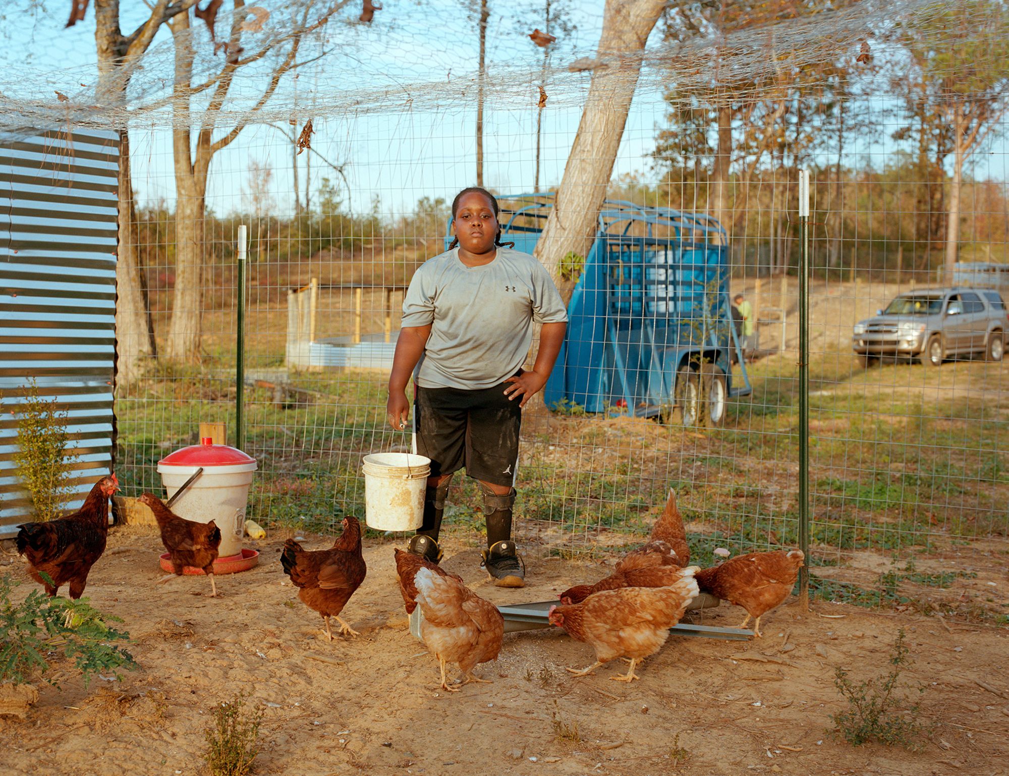 "Nolan at His Dad’s Chicken Coop, 2020," by Fumi Nagasaka. The photographer returned to this small community for six years.