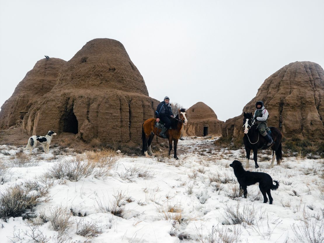 Two men on horseback with centuries-old ancestral tombs close to where Soyuz descent modules land back on Earth.