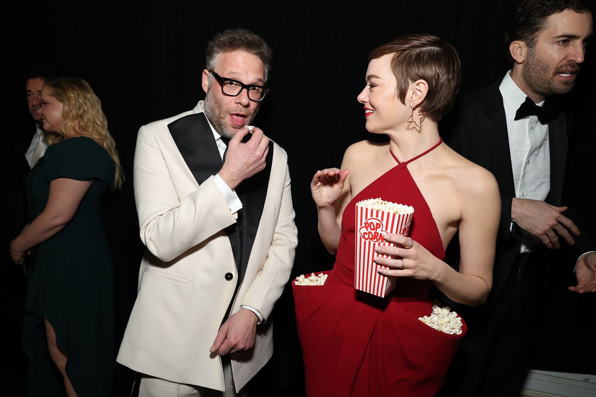 Seth Rogen and Emma Stone, both attendees of the 50th anniversary celebration of Saturday Night Live, snacked on the actor's popcorn-filled dress.