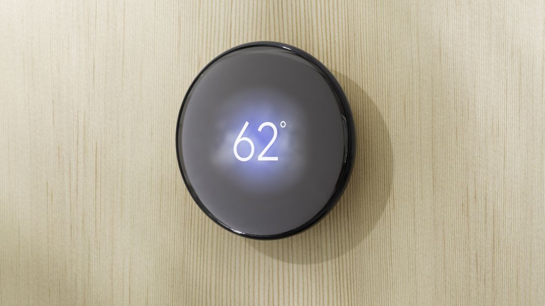 The obsidian Nest Learning Thermostat (2024) on a light wood wall, with a 62 degree readout