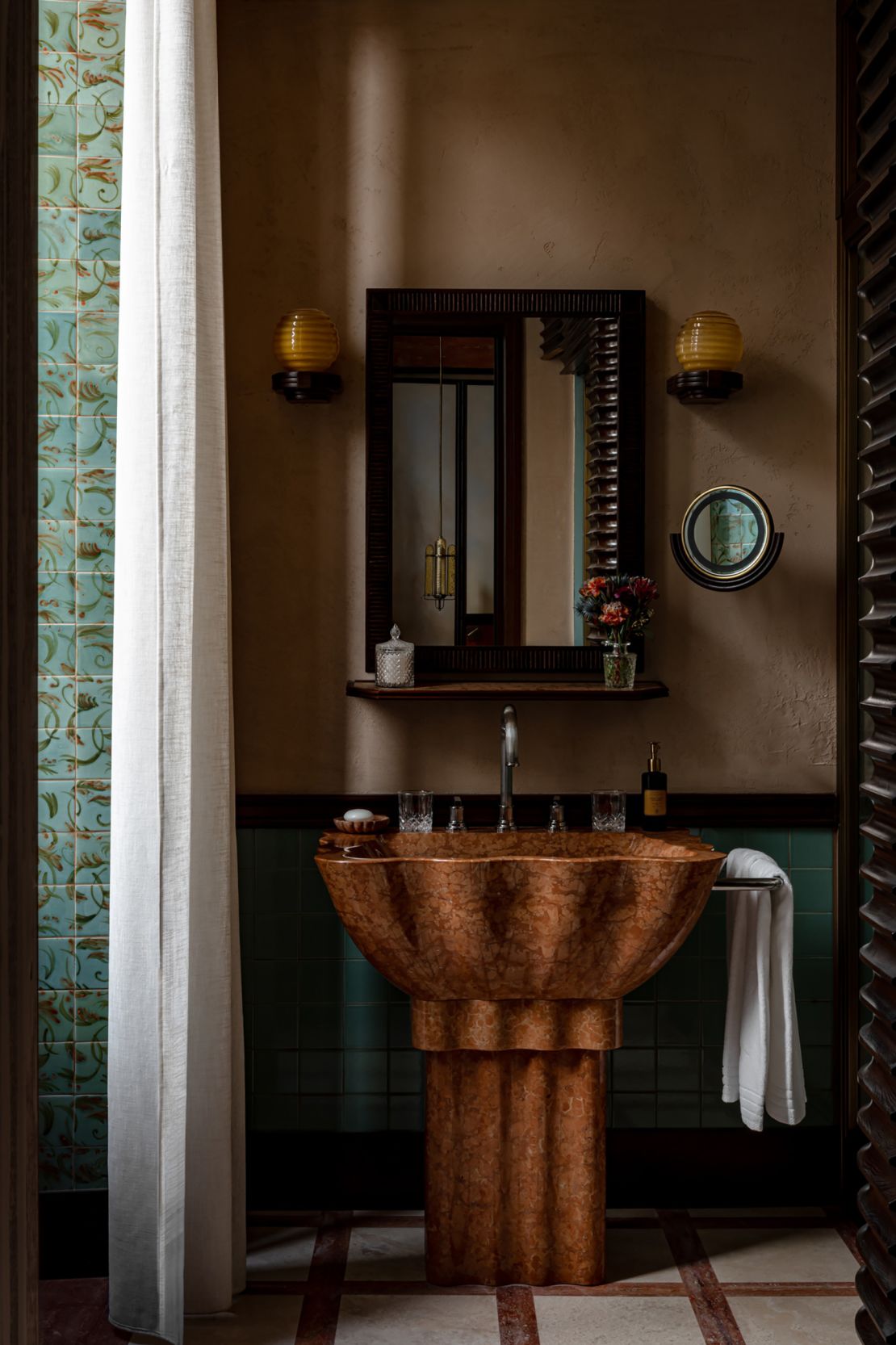 Bathrooms at La Minerva are constructed from marble and include shell-shaped sinks and walk-in showers.