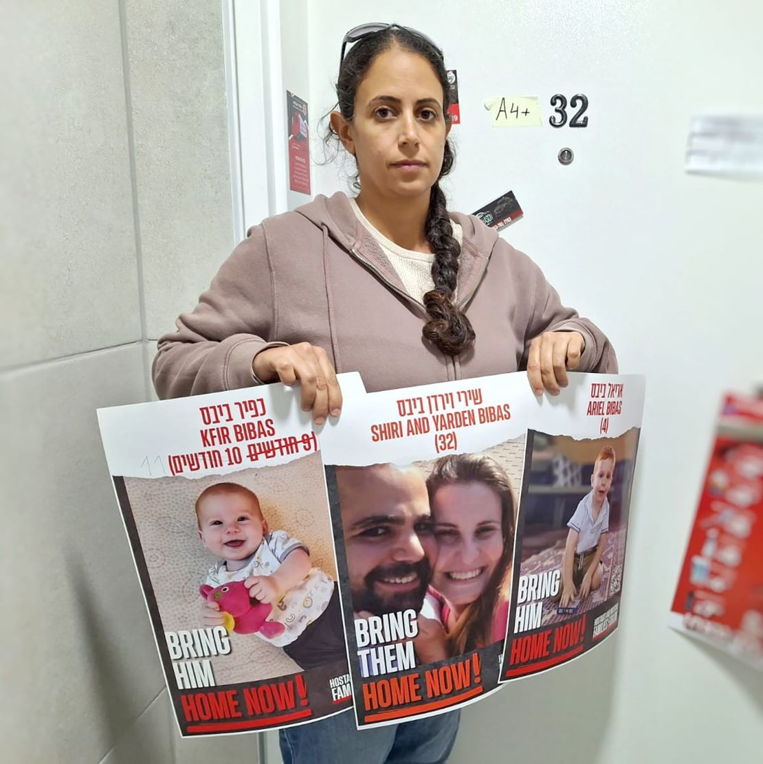 Ofri Bibas Levy holds posters of her family, including her brother, Yarden Bibas, taken hostage in Gaza.