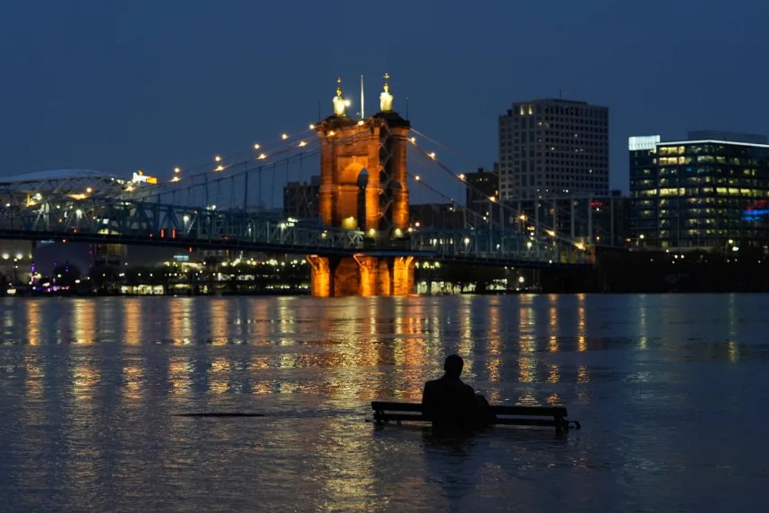 La crecida del río Ohio sumerge parcialmente la estatua de bronce de James Bradley a lo largo de Riverside Drive, el domingo, en Covington, Kentucky.