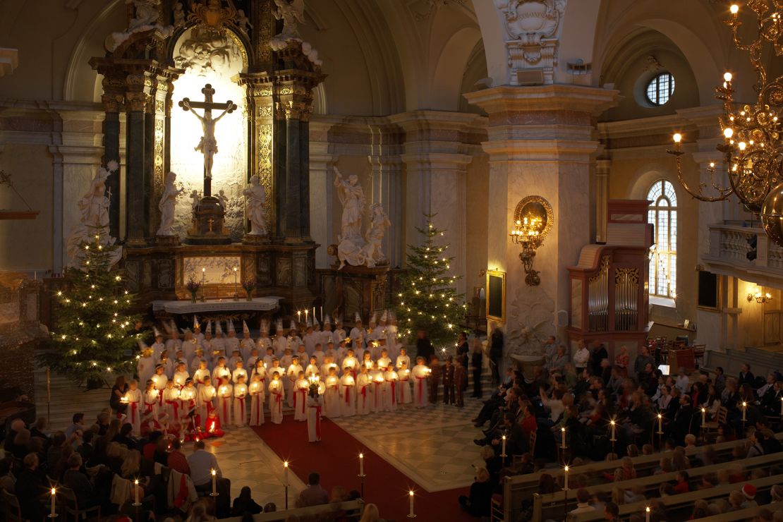 An early morning Lucia Day procession takes place in Gustaf Vasa church in Stockholm.