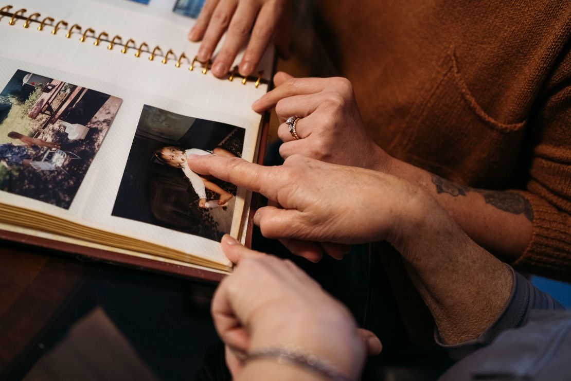 Maralee Hill and her daughter Victoria Hill look through old family albums in Wethersfield, Connecticut.