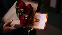 Maz George holds flowers and a pamphlet after Cecilia Gentiliâs funeral at St. Patrick's Cathedral in New York City, on February 15.