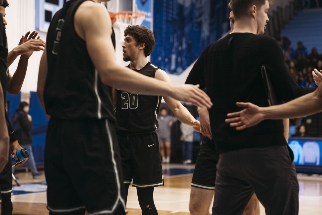 Romeo Myrthil, center, and fellow teammates shake hands during the game against Columbia University.