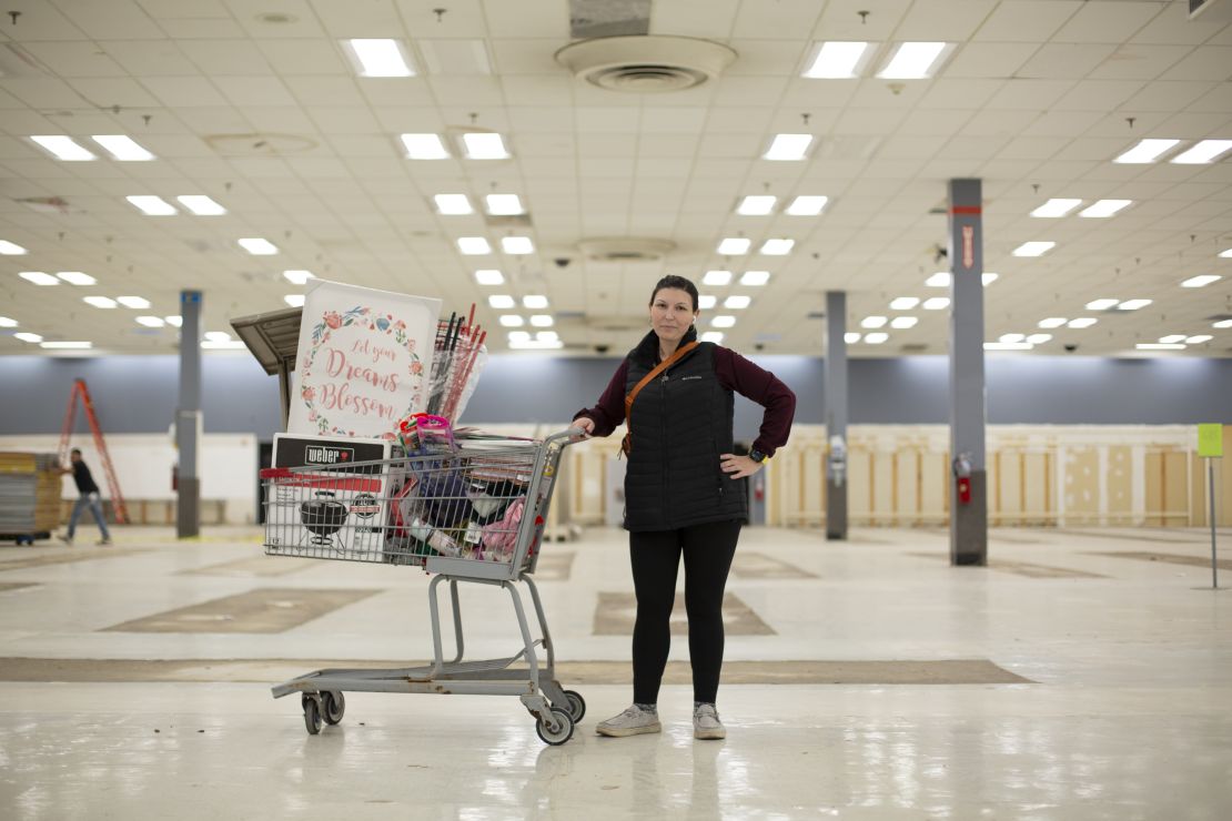 Jessica Cohan poses for a portrait with her full shopping cart.