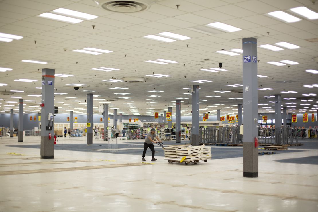 A worker pushes a cart through the empty section in the Bridgehampton Kmart the size of a football field.