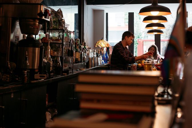 Bartenders at Book Club Bar in the East Village ring up book purchases as well as serve beer and cleverly named cocktails such as an In Cold Bloody Mary and Whiskey the Pooh.