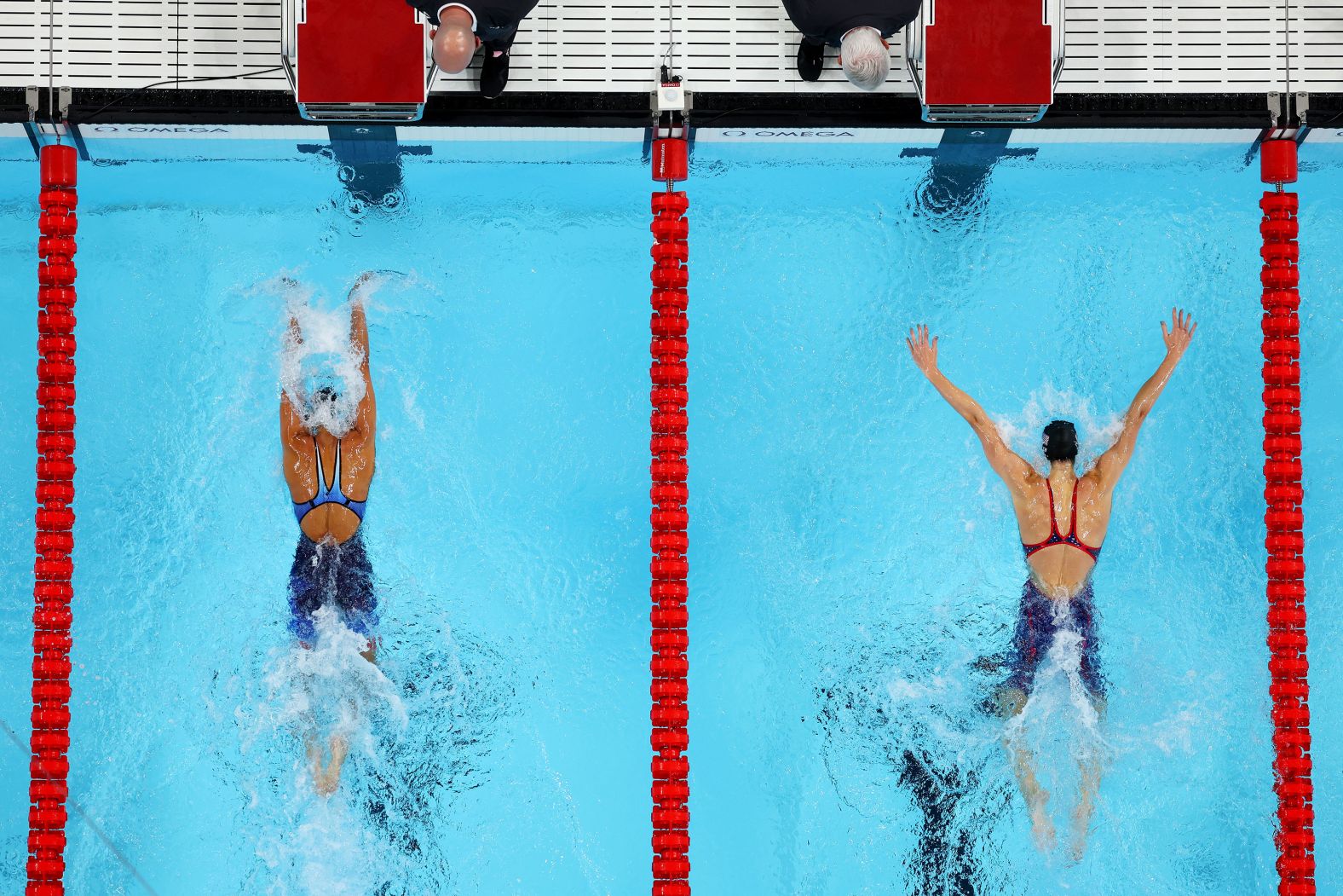 American swimmer Torri Huske, left, edges teammate Gretchen Walsh as they <a >finish 1-2 in the 100-meter butterfly</a> on July 28.