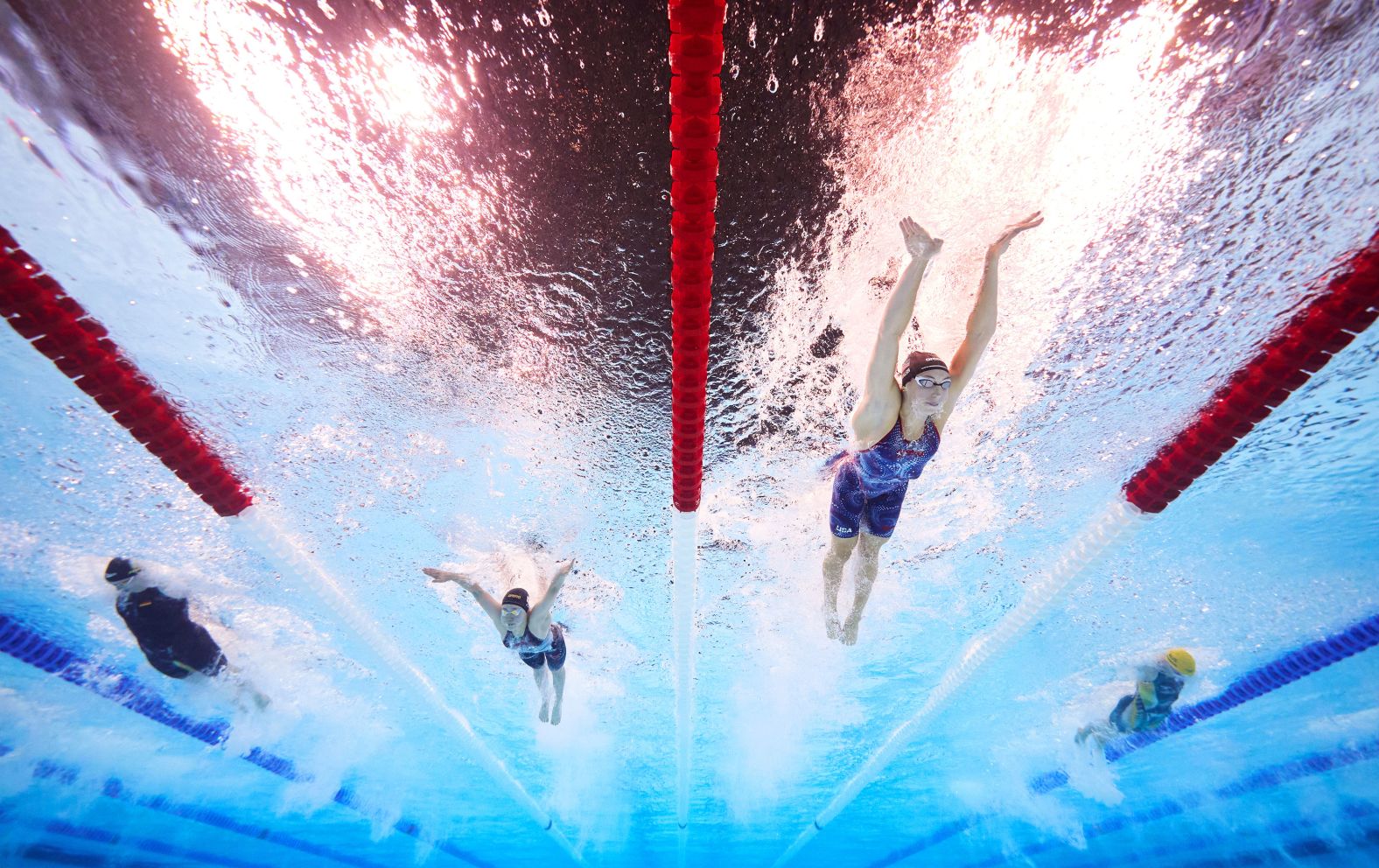 US swimmer Gretchen Walsh, second from right, <a >set a new Olympic record in the 100-meter butterfly</a> during a semifinal race on July 27. She finished in 55.38 seconds.