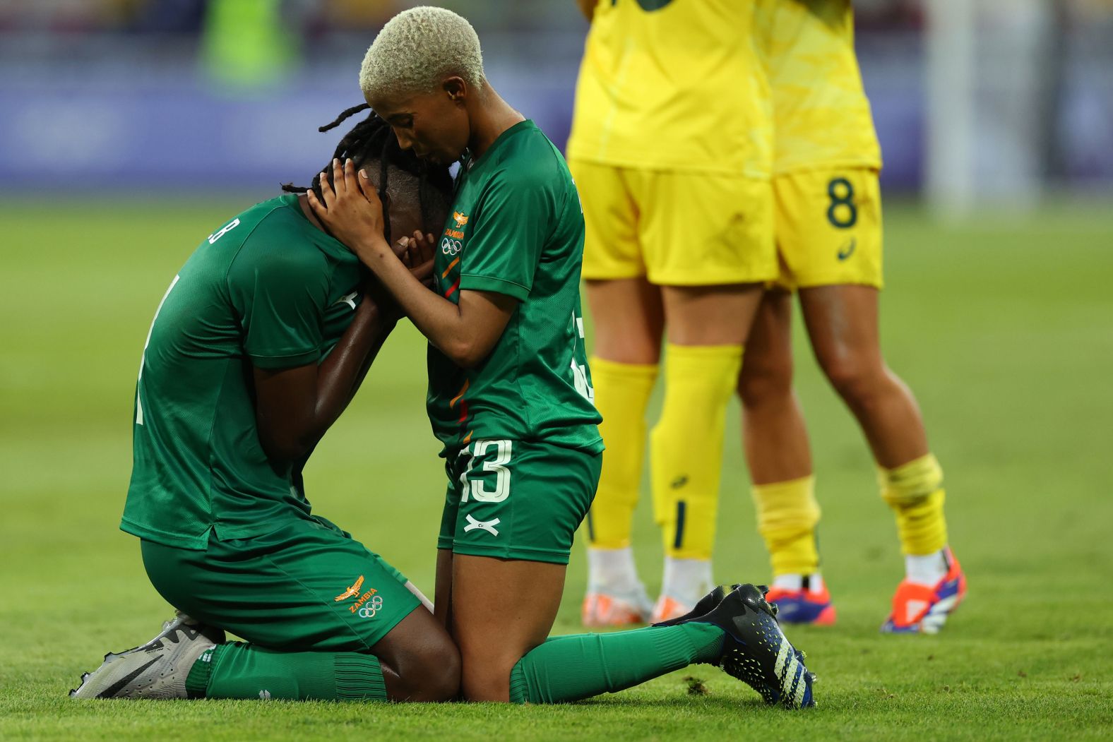 Zambia's Martha Tembo consoles teammate Barbra Banda after Australia <a >came back from a 5-2 deficit to win 6-5</a> in their soccer match on July 28.